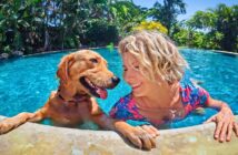 smiling woman in her 40s in a swimming pool with her dog - illustrating picking herself up after divorce