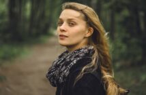 10 Fateful Decisions That Will Shape Your Future (For Better Or Worse) young woman looking back over her shoulder to camera as she walks a forest path