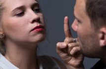 woman who is speaking to her partner in a controlling way and pointing her finger