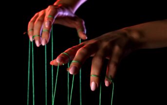 woman's hands with puppet strings attached to her fingers - illustrating micromanaging a relationship