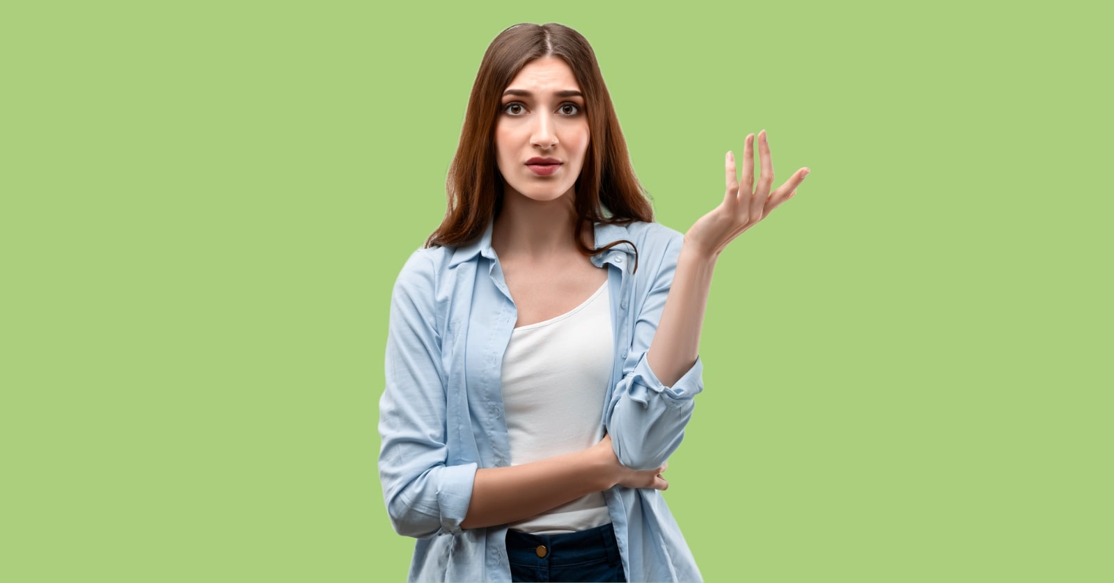 young brunette woman displaying petty body language with one hand slightly raised as if to say "so what?"