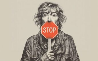 A grayscale portrait of a woman holding a red stop sign in front of her mouth, covering her lower face. She has tousled hair and wears a scarf and jacket, set against a plain background.