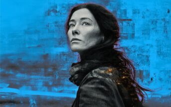A woman with long dark hair and a serious expression looks up against a textured blue and gray background, her face partially illuminated by warm light. She wears a dark scarf and coat.