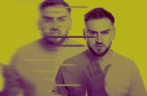 A man with a beard and short hair is standing against a yellow background. His expression shifts from calm to angry, creating a blurred effect with horizontal lines across the image. He raises one hand slightly.