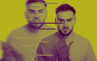 A man with a beard and short hair is standing against a yellow background. His expression shifts from calm to angry, creating a blurred effect with horizontal lines across the image. He raises one hand slightly.