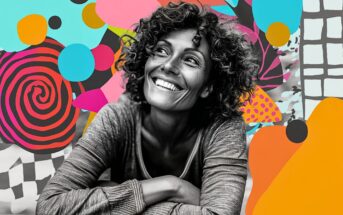 A smiling woman with curly hair leans forward against a colorful, abstract background with bold shapes, swirls, and patterns. The woman is in black and white while the vibrant backdrop contrasts behind her.