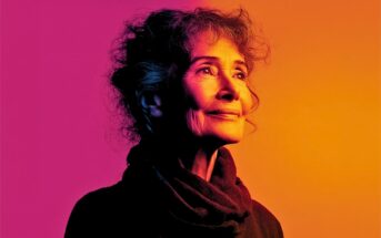 An older woman with curly hair looking upward against a vibrant magenta and orange gradient background.