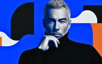 A man with gray hair and a beard, wearing a black turtleneck, poses thoughtfully with his hand on his chin against a bold blue background with abstract black, white, and orange shapes.