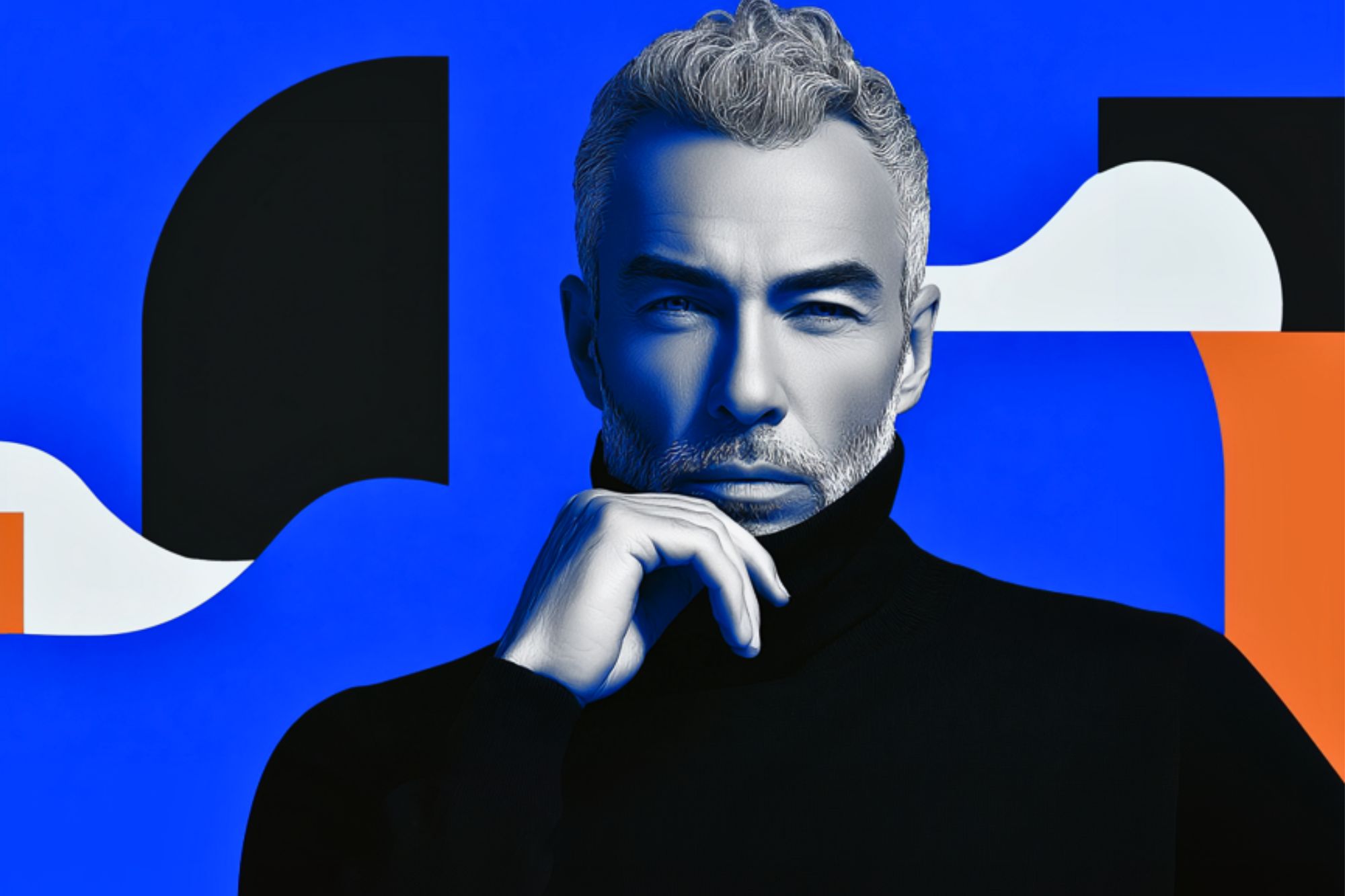 A man with gray hair and a beard, wearing a black turtleneck, poses thoughtfully with his hand on his chin against a bold blue background with abstract black, white, and orange shapes.