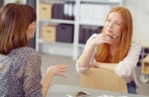 two women colleagues having a conversation in an office