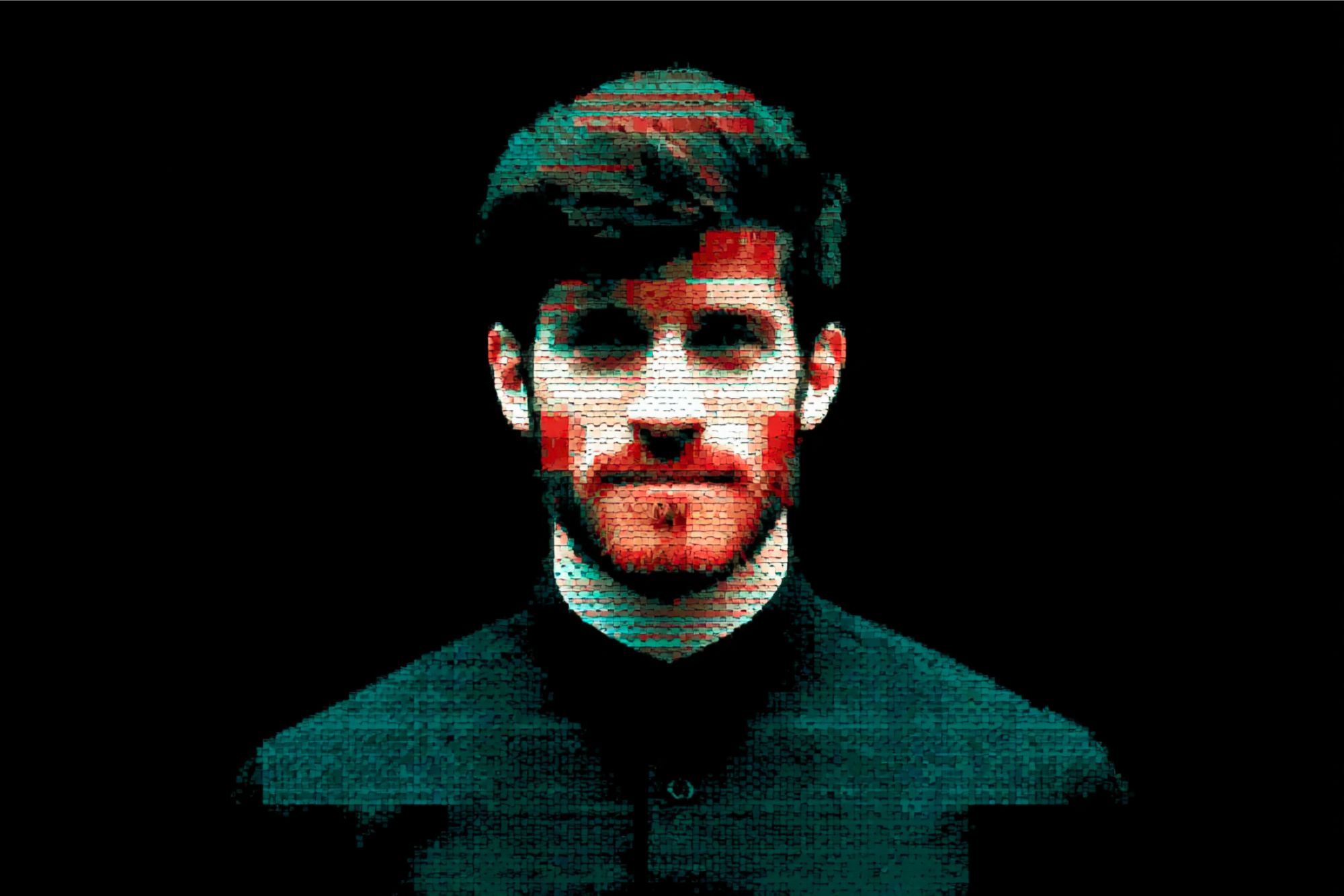 A stylized, pixelated portrait of a man with dark hair and a beard, facing forward against a black background. Red and blue digital glitch effects appear on his face and clothes.