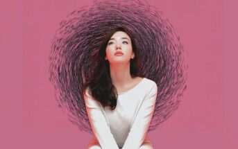 A woman in a white outfit sits against a pink background, looking upward. Behind her, a swirling pattern of black lines forms a circular shape, creating a halo-like effect.