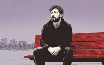 An illustration of a man with dark hair and a beard sitting on a red bench, looking contemplative. A city skyline is visible in the background under a pale purple sky with a few birds flying.