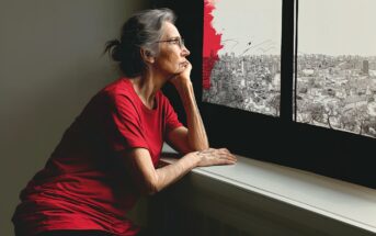 An elderly woman in a red shirt gazes thoughtfully out a window at a cityscape, with part of the view illustrated in black, white, and red sketch style.