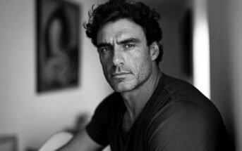 Black and white portrait of a man looking directly at the camera.
