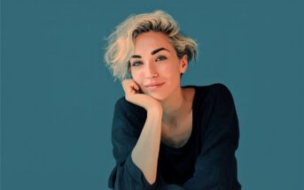 Digital illustration of a person with short, wavy blonde hair, wearing a dark top, resting their chin on their hand, and smiling slightly against a solid teal background.