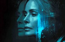 A woman’s face, lit with blue light, is shown in profile beside a blurred reflection. Blue paint-like splashes add an abstract element, creating a mysterious, introspective mood.