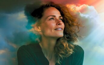 A woman looking upward, with a double exposure effect blending her profile into a cloudy sky with rays of light.