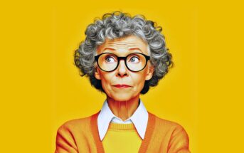 An older woman with short, curly gray hair and glasses looks upward. She wears an orange sweater over a white collared shirt, standing against a solid yellow background.