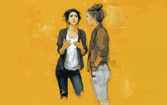 Two women stand facing each other against a textured yellow background. One gestures with her hands while speaking, and the other listens with her hands in her pockets. Both appear engaged in conversation.