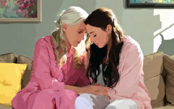 An older woman and a younger woman sit close together on a couch, both wearing pink pajamas. They touch foreheads and hold hands, sharing a comforting, emotional moment. Sunlight streams in from the side.