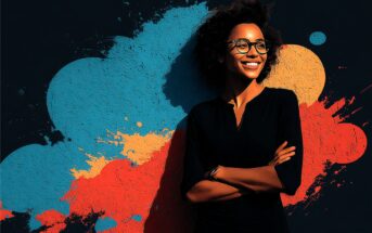A smiling woman with curly hair and glasses stands confidently with arms crossed, in front of a dark background featuring vibrant blue, red, and orange paint splashes.