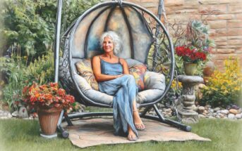 A woman with white hair in a blue dress sits relaxed on a cushioned hanging chair in a garden, surrounded by flowers, greenery, and a stone wall.