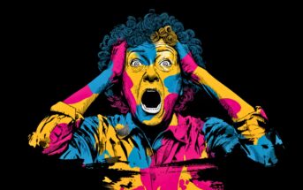 A person with curly hair holds their head and screams in shock. Their face and clothes are painted in bold, vibrant blue, yellow, and pink colors against a black background.