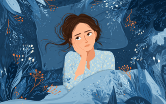 A young woman with brown hair lies in bed, resting her head on one hand and looking up thoughtfully. She is surrounded by dark blue bedding and floral patterns, creating a calm, dreamy atmosphere.