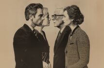 Four people stand in two pairs, facing each other closely. Each pair consists of one man and one woman, all dressed in formal clothing and appearing engaged in intense, focused conversation. The image has a vintage feel.