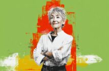 An older woman with short gray hair stands confidently with arms crossed, wearing a white shirt. The background is green with bold orange and yellow brush strokes behind her.