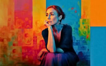 A woman sits thoughtfully with her chin on her hand against a vibrant, abstract background of orange, blue, and yellow blocks and swirls.