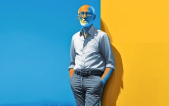 An older man with a white beard and glasses stands with hands in pockets, leaning against a bright yellow wall next to a blue background. He wears a light shirt and gray pants, with blue and yellow lighting on his face and body.
