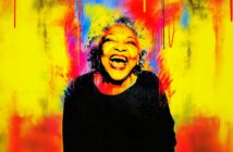 A joyful older woman with curly gray hair laughs brightly, surrounded by a vibrant background of yellow, red, and blue, creating an energetic, colorful, and uplifting atmosphere.