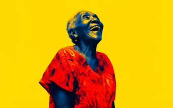 An elderly woman wearing a bright red patterned top laughs joyfully, her face and skin rendered in blue tones, set against a vibrant yellow background.