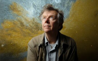 A man with light hair and a thoughtful expression looks upward, standing in front of a swirling, starry background reminiscent of Van Gogh's "Starry Night," with blue, yellow, and gold tones.