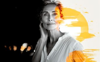 A grayscale portrait of an older woman with short hair and a white shirt, looking calmly at the camera. The right side of the image features bright orange paint strokes and a sun-like circle.