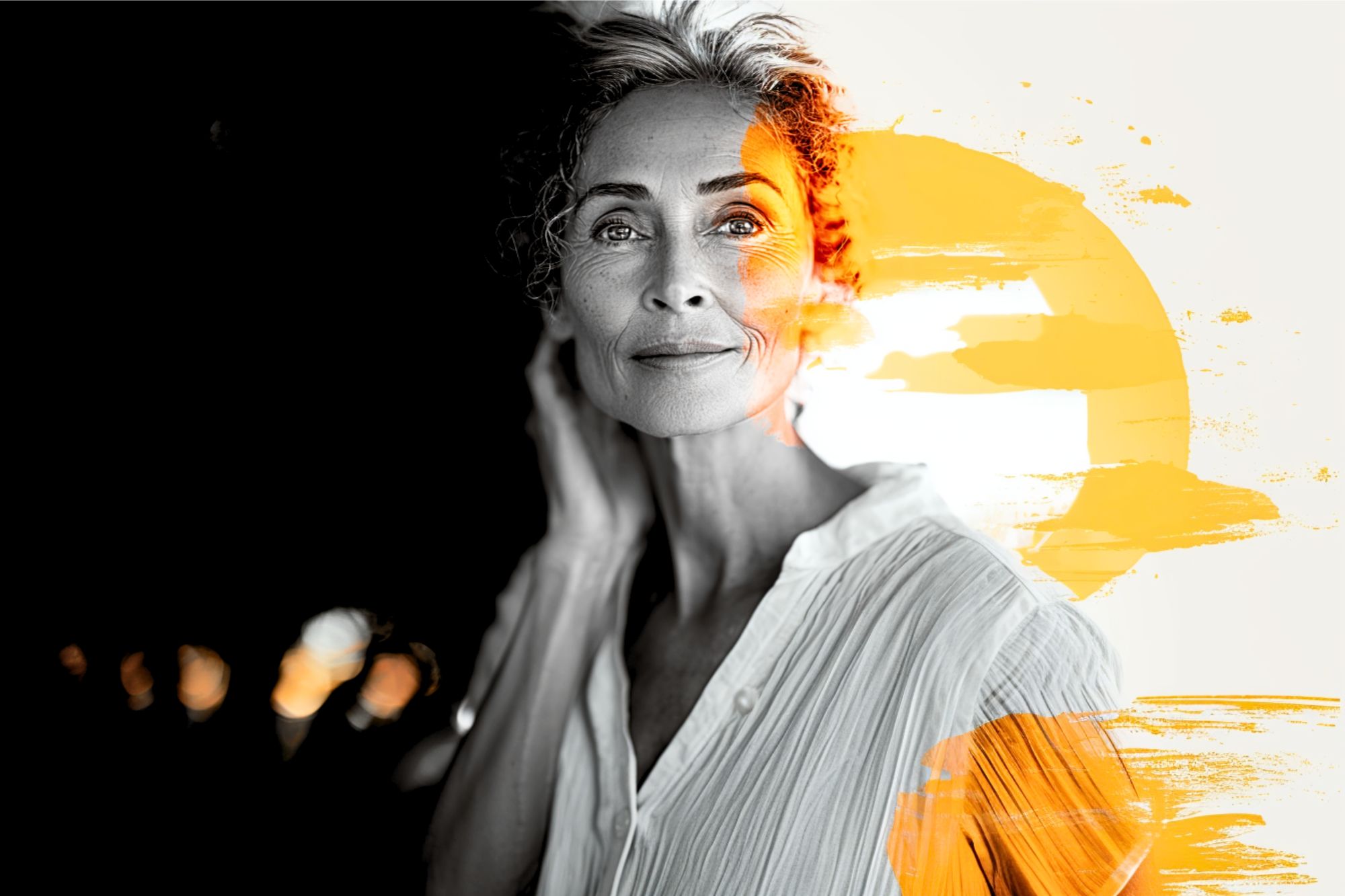A grayscale portrait of an older woman with short hair and a white shirt, looking calmly at the camera. The right side of the image features bright orange paint strokes and a sun-like circle.