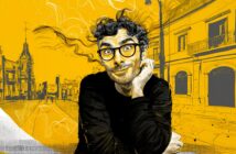 A curly-haired person with glasses and a playful expression rests their chin on their hand. The background is a vibrant, yellow-toned city street illustrated in a sketchy style.