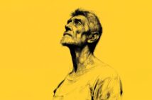 A sketch-style portrait of an older man with a beard looking upwards, set against a bright yellow background. He wears a simple T-shirt and has a contemplative expression.