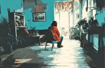 A person in a red shirt sits alone on a chair in a sunlit, plant-filled room, facing toward large open doors with natural light streaming in, casting shadows on the wooden floor.