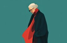 A woman with white hair in a bun, wearing glasses, a dark coat, and a flowing red scarf, stands against a teal background, looking downward with her hand in her pocket.