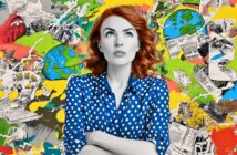 A woman with red hair in a blue polka-dot shirt stands with arms crossed, looking upward thoughtfully. Behind her is a colorful, chaotic collage of world maps, paperwork, and illustrations.