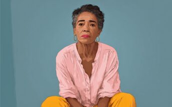 Illustration of an older woman with short gray hair, wearing a pink blouse and yellow pants, sitting and looking directly at the viewer against a plain blue background.
