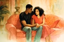 A young couple sits closely on a red couch, holding hands and looking into each other's eyes with serious expressions in a warmly lit room.