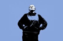 A stylized image of a person standing with hands on hips, looking upward against a solid blue background. The person is wearing a dark sweater and appears confident and contemplative.