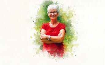 An older woman with short gray hair and glasses stands smiling with her arms crossed, wearing a red shirt, against a watercolor-style green and white background.