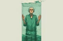 An older person with glasses and gray hair stands partially submerged in a tall glass tank filled with water, hands pressed against the glass, looking upward with a serious expression. Water splashes at the top of the tank.