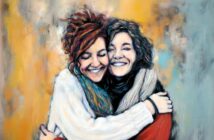 Two women with curly hair are smiling and hugging each other warmly. Both are wearing cozy sweaters and scarves. The background is a blend of soft, abstract yellow and gray tones, giving the image a painted, artistic feel.