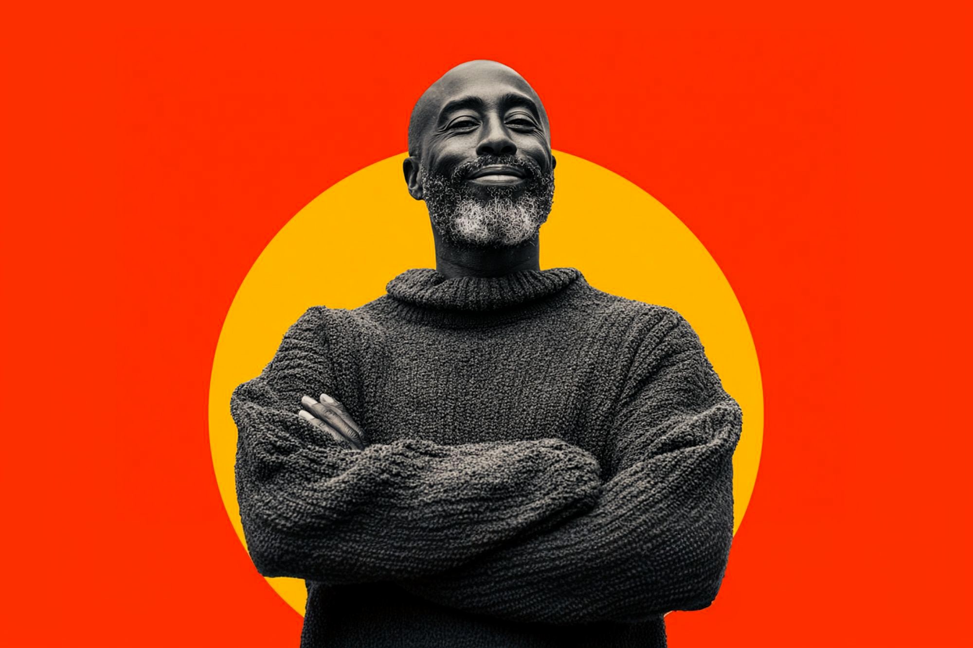 A man with a beard and mustache wearing a thick knit sweater stands with arms crossed, smiling confidently. The background features a large yellow circle on a vibrant red backdrop.